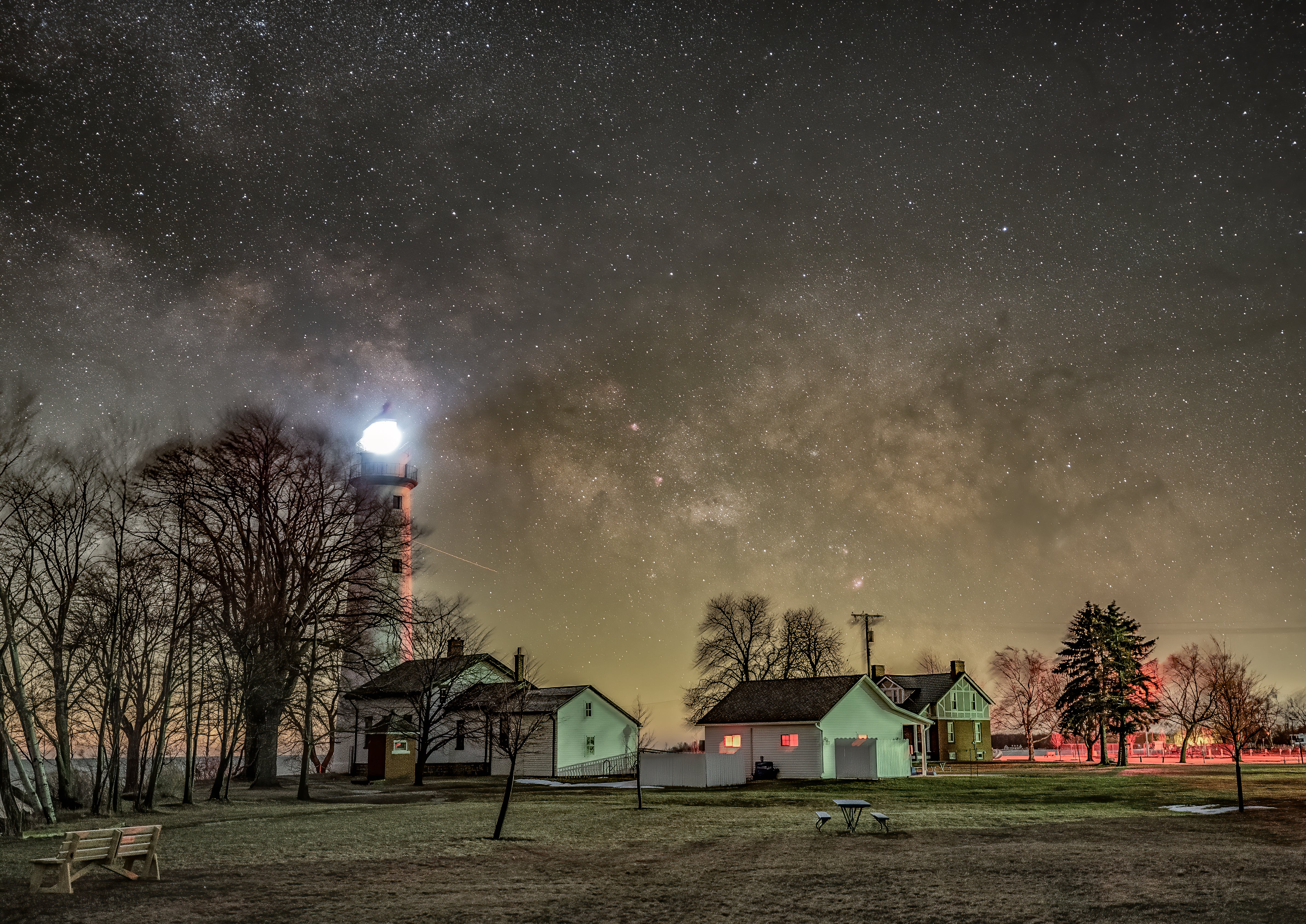 The Milky Way rises over the Point aux Barques Lighthouse on Lake Huron. The two-minute sky and ground frames of this composite were taken at f/2.8 and ISO 1600.